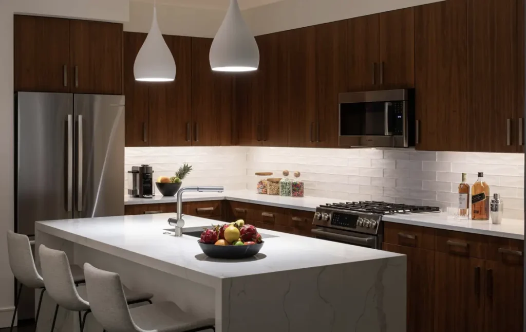 This is a photograph of a modern and minimalist kitchen design with high-end finishes and very meticulous lighting