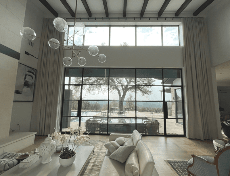 double-height ceiling floor-to-ceiling motorized drapes installed in modern Austin home