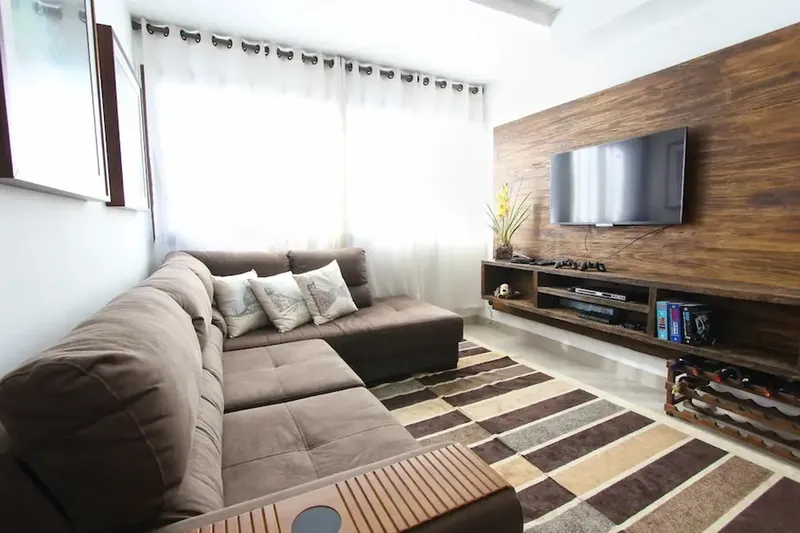 Barton Creek home living room with wall mounted TV and integrated surround sound system